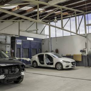 Newly repaired cars being prepared for the spray paint booth